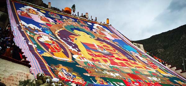 The large-scale Buddhist Thangka showing on the platform in Drepung Monastery.